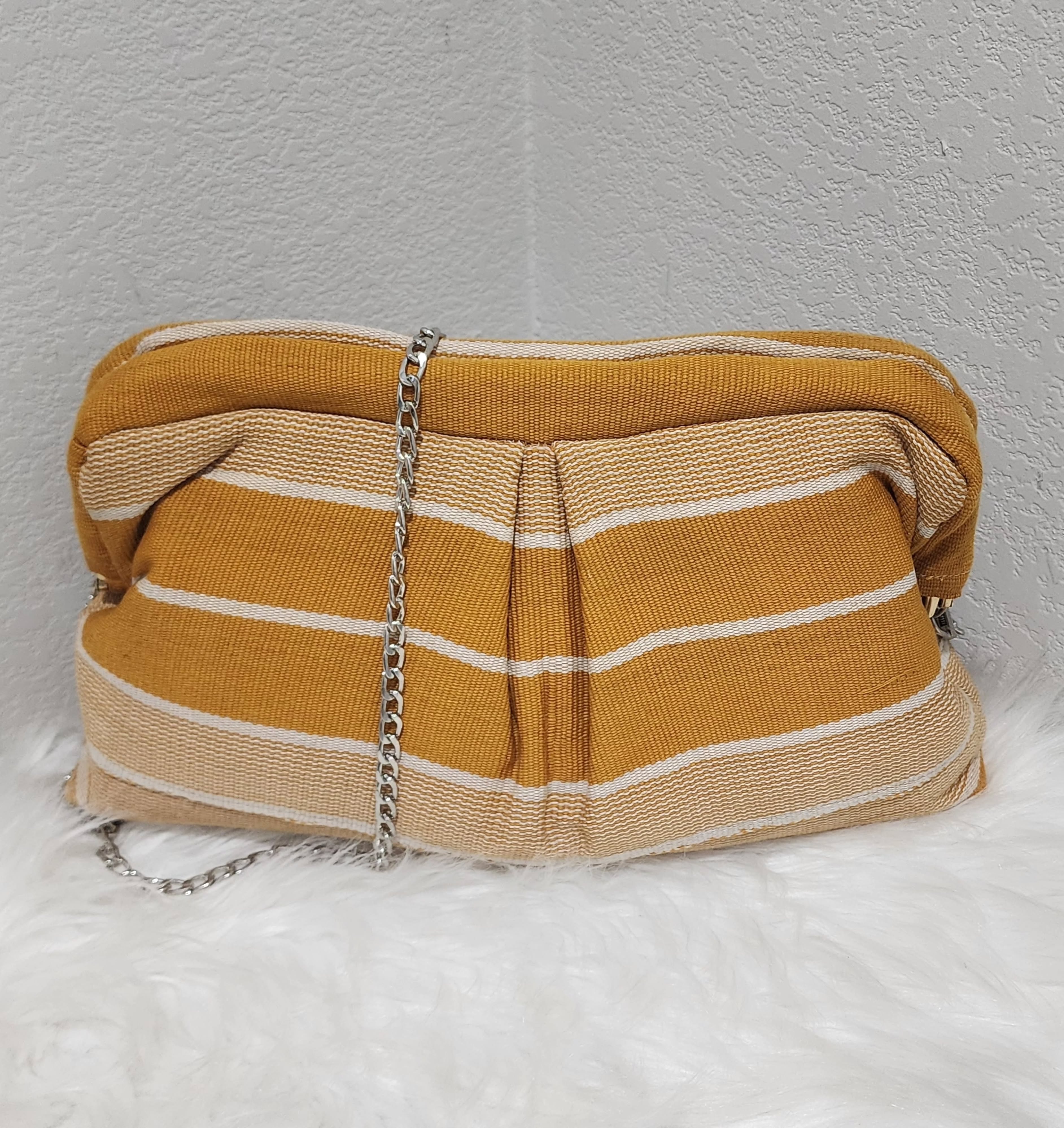 A handcrafted Ankara-print clutch with chain strap by Uwakstar Designs